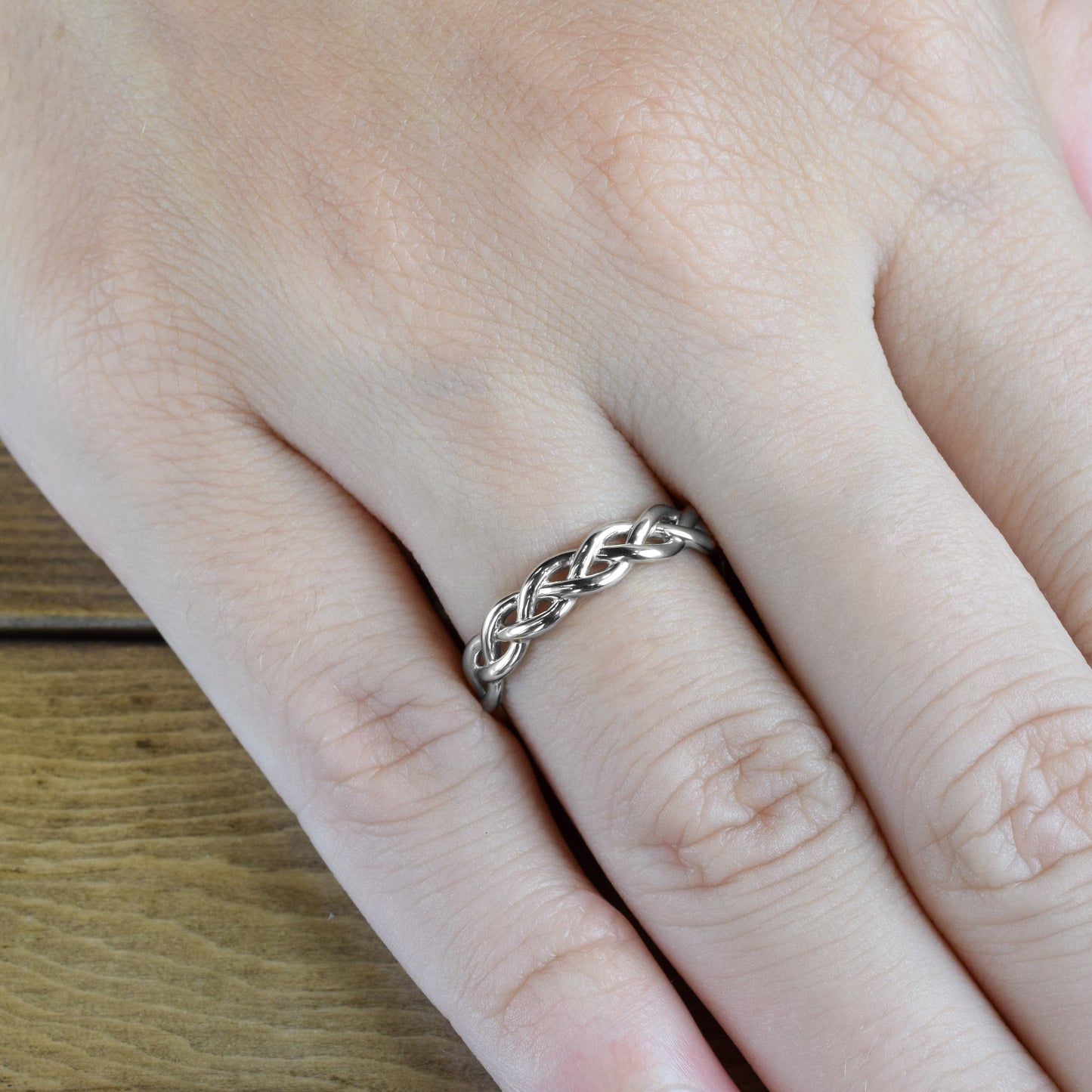 braided white gold strands ring on finger