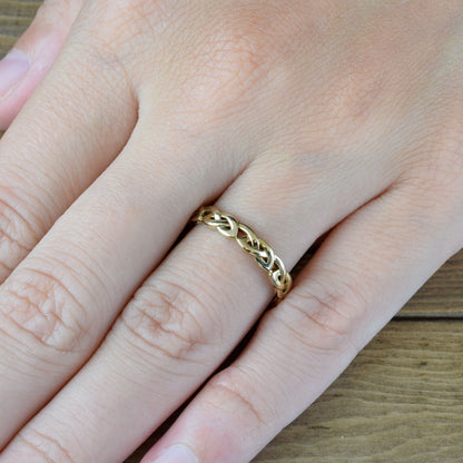 love know ring in yellow gold on finger