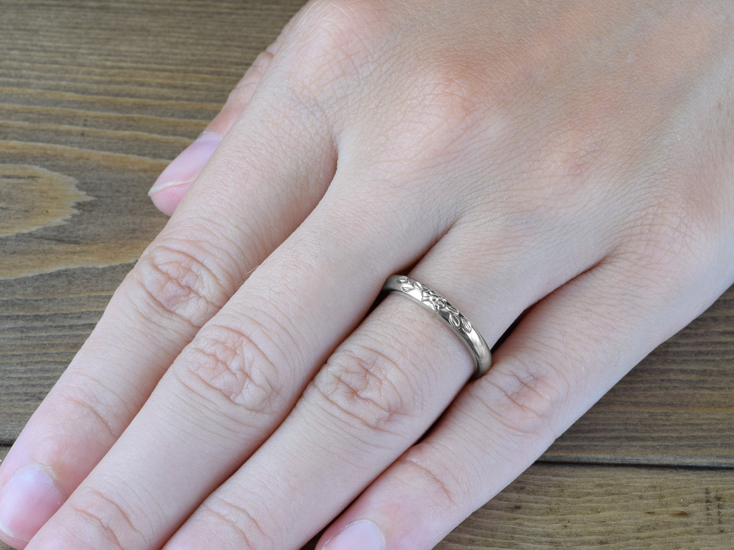 Vintage Style Wedding Band with Leaves in 14k white gold on finger