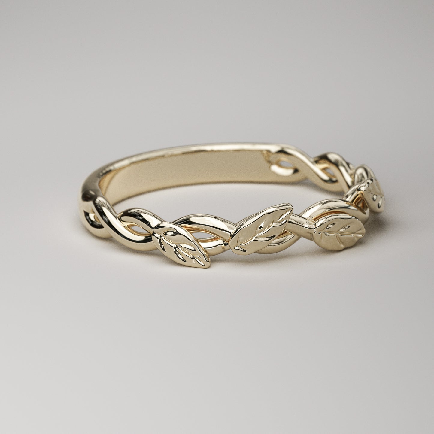 intertwined vine ring with leaves in yellow gold
