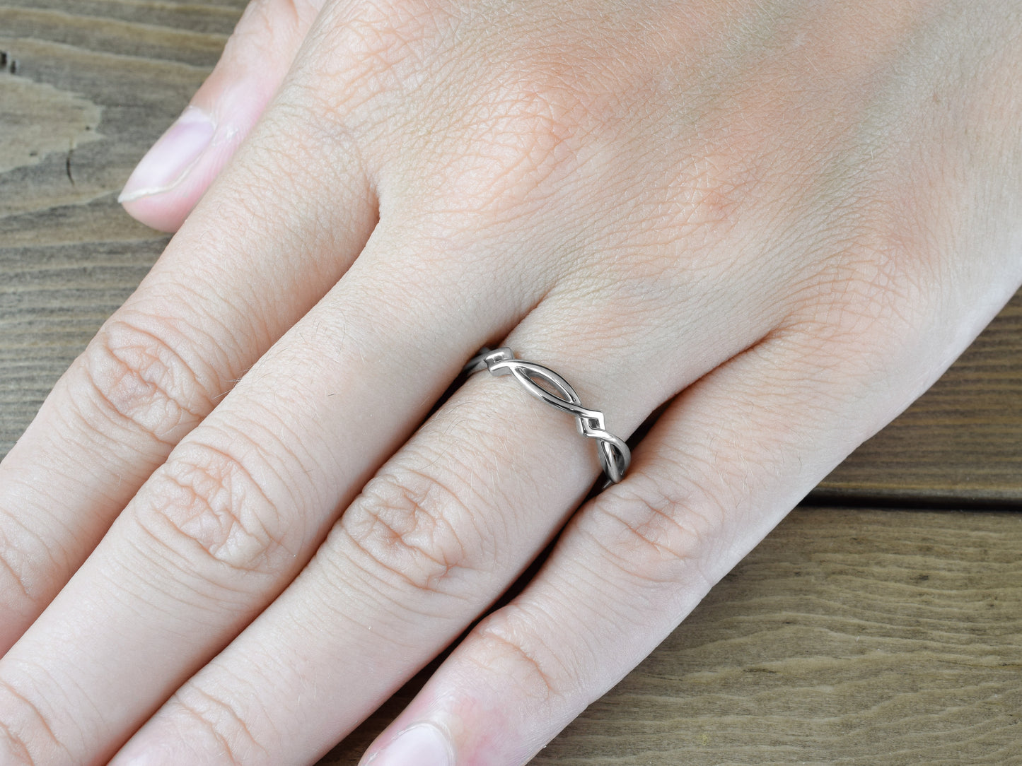 Simple Celtic weave band in solid 14k or 18k white gold on finger