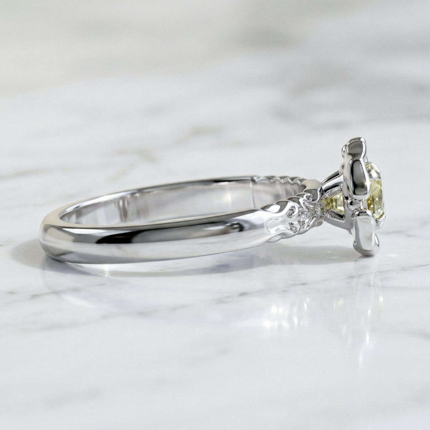 A yellow sapphire engagement ring with a stylized flower petal setting, made of white gold.