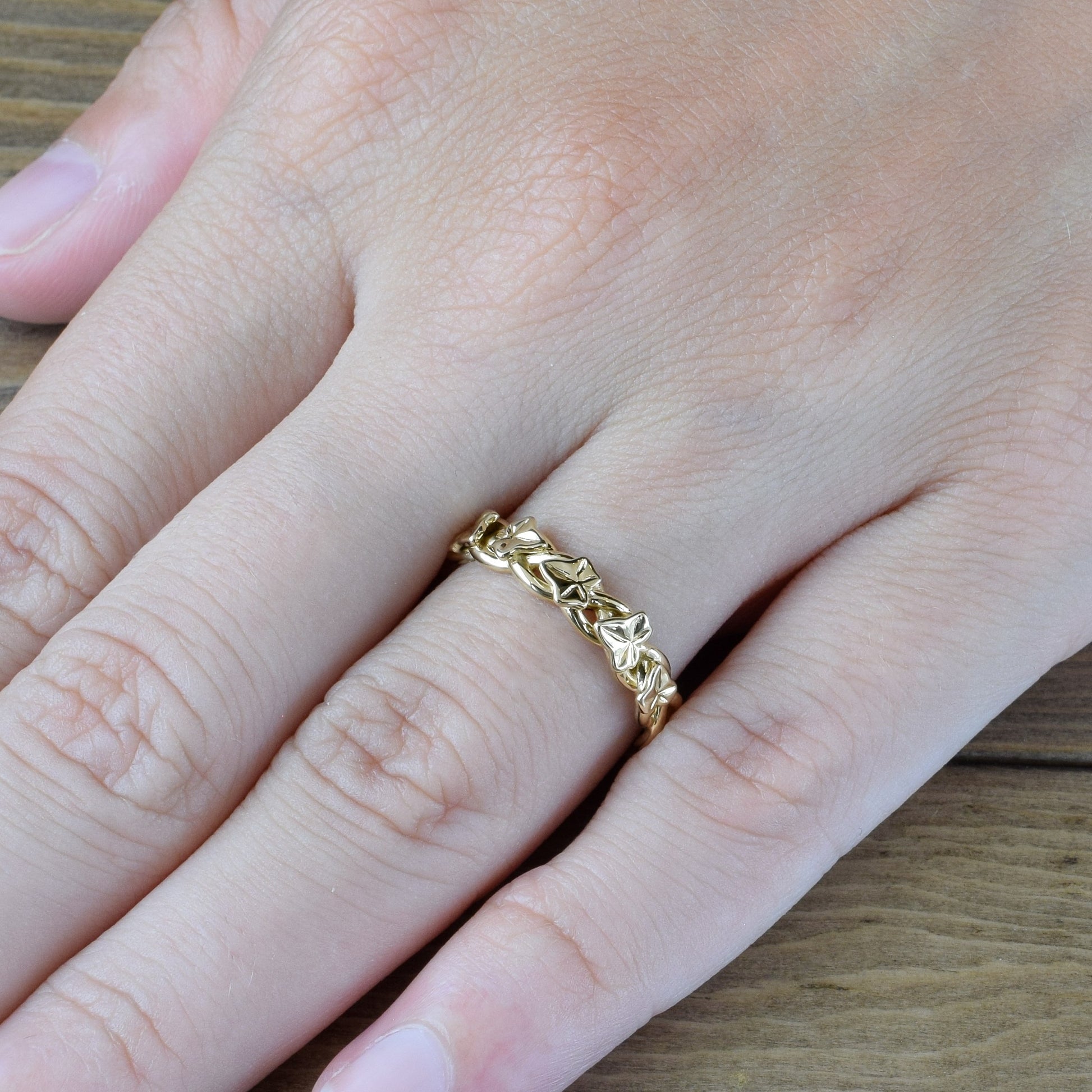 braided ivy vines with leaves ring in yellow gold on finger