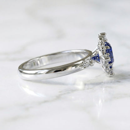 White gold ring with blue sapphire and diamond accents 
