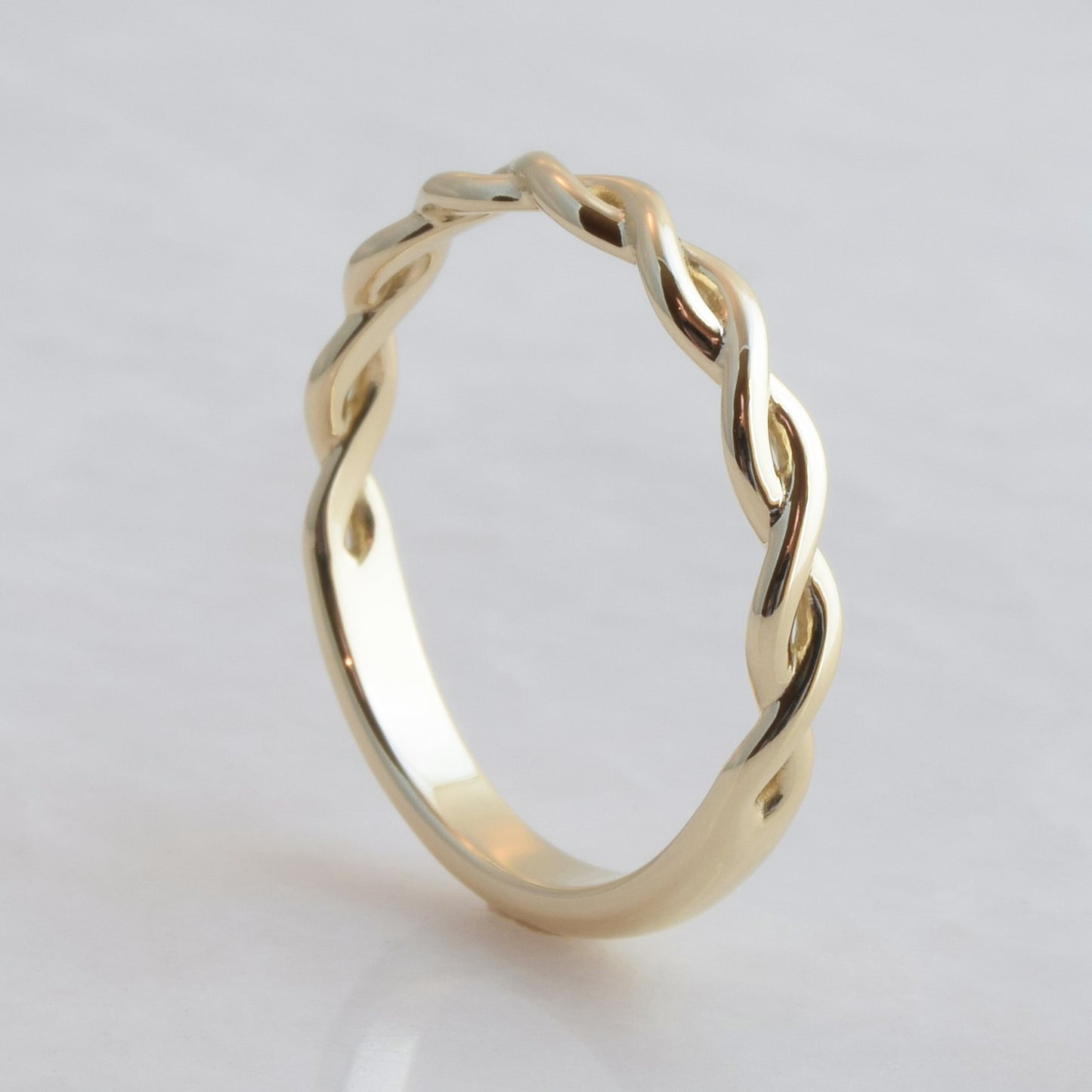 Interwoven gold strands ring band