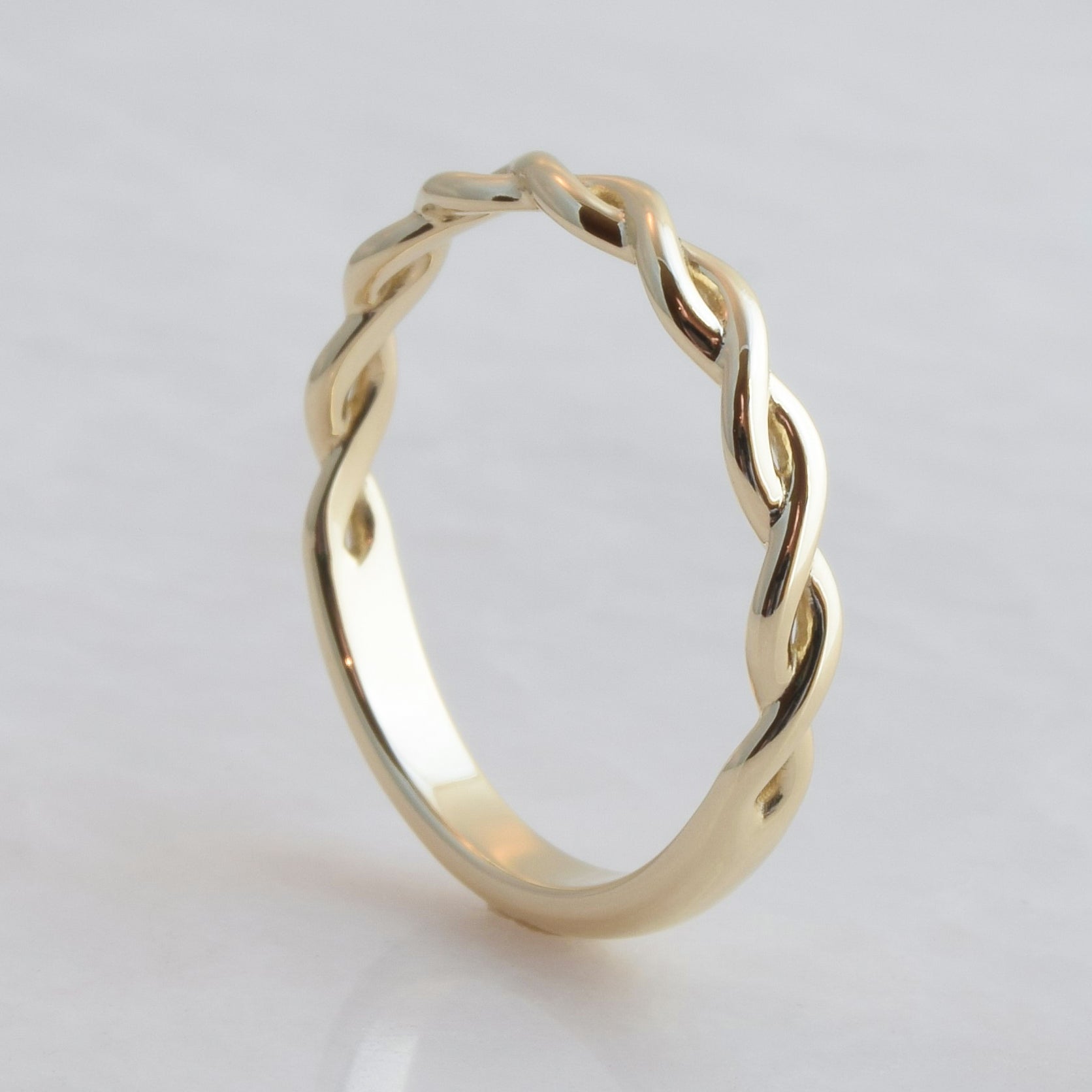 Interwoven gold strands ring band