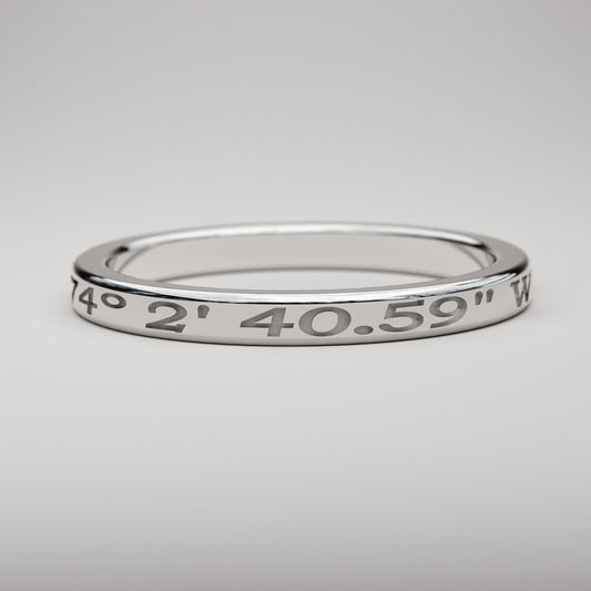 narrow custom engraved coordinates ring in white gold
