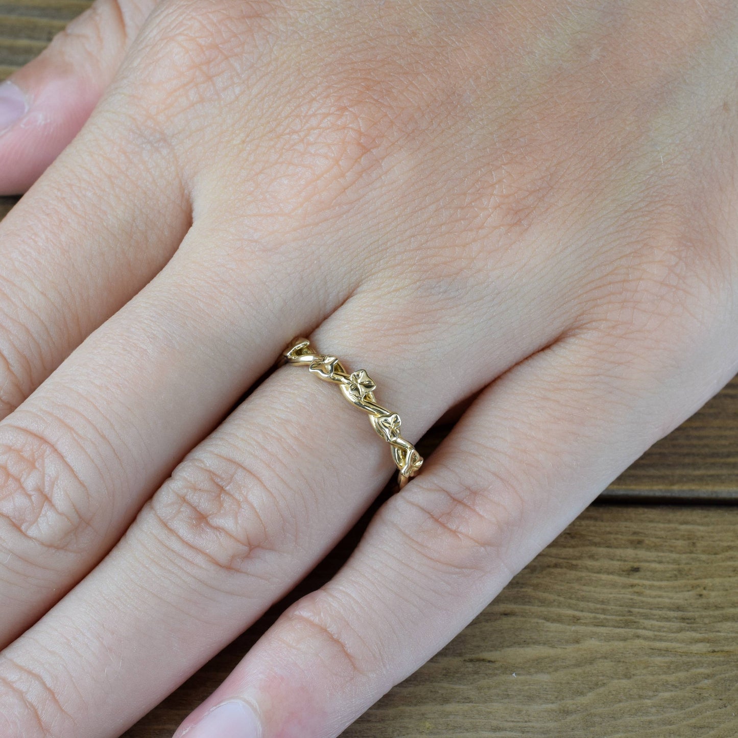 intertwined ivy vine ring in yellow gold on finger
