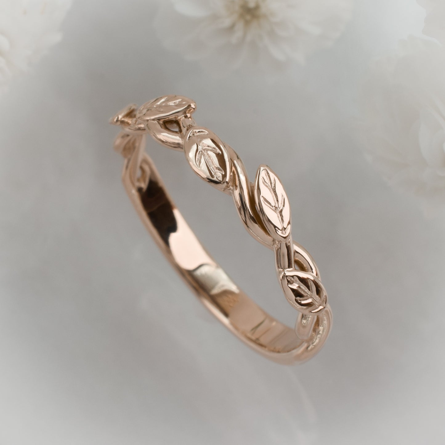 intertwined vine ring with leaves in solid rose gold - oblique view