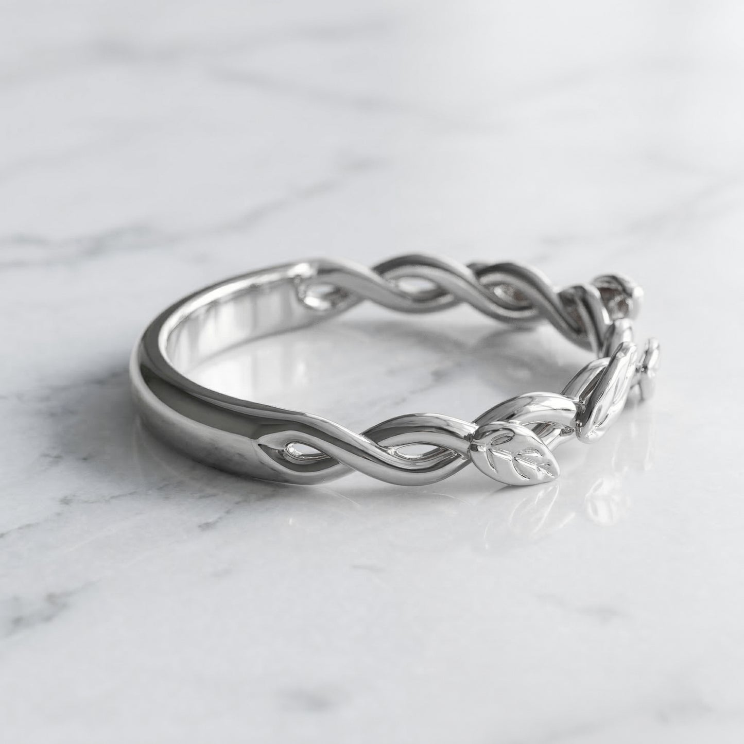 white gold ring with interwoven strands and leaves