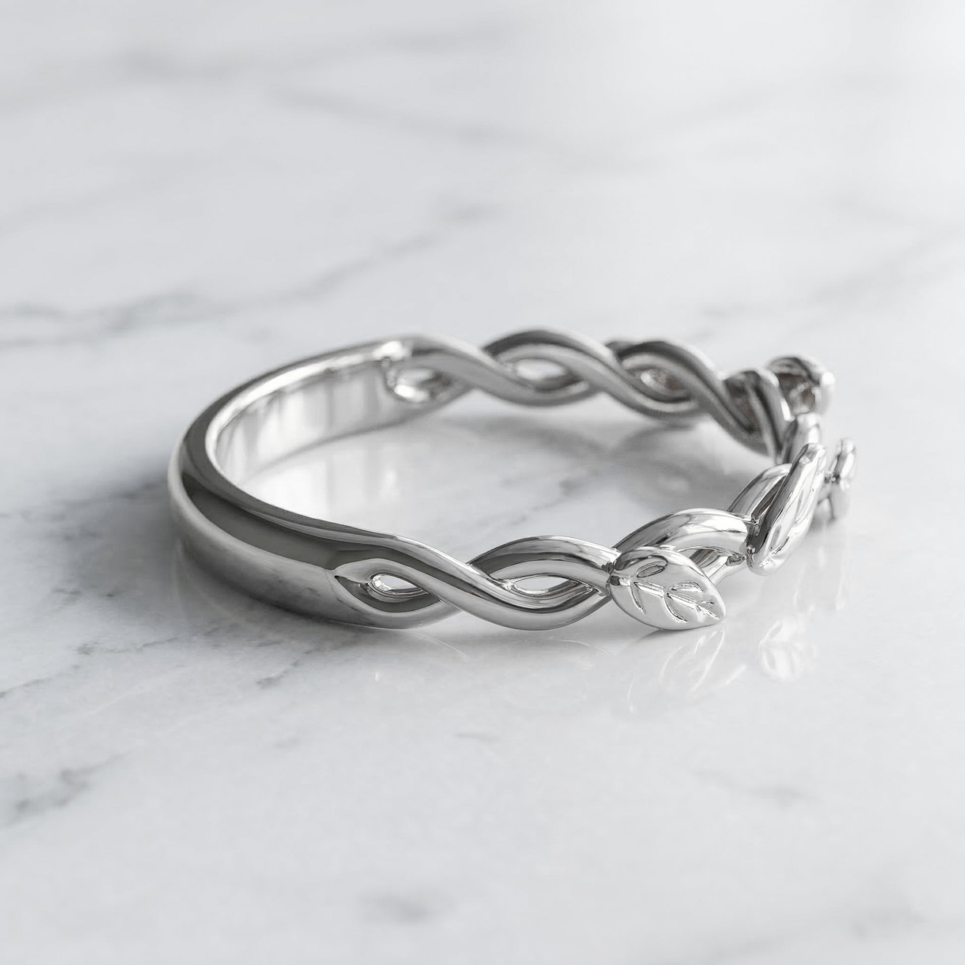 white gold ring with interwoven strands and leaves