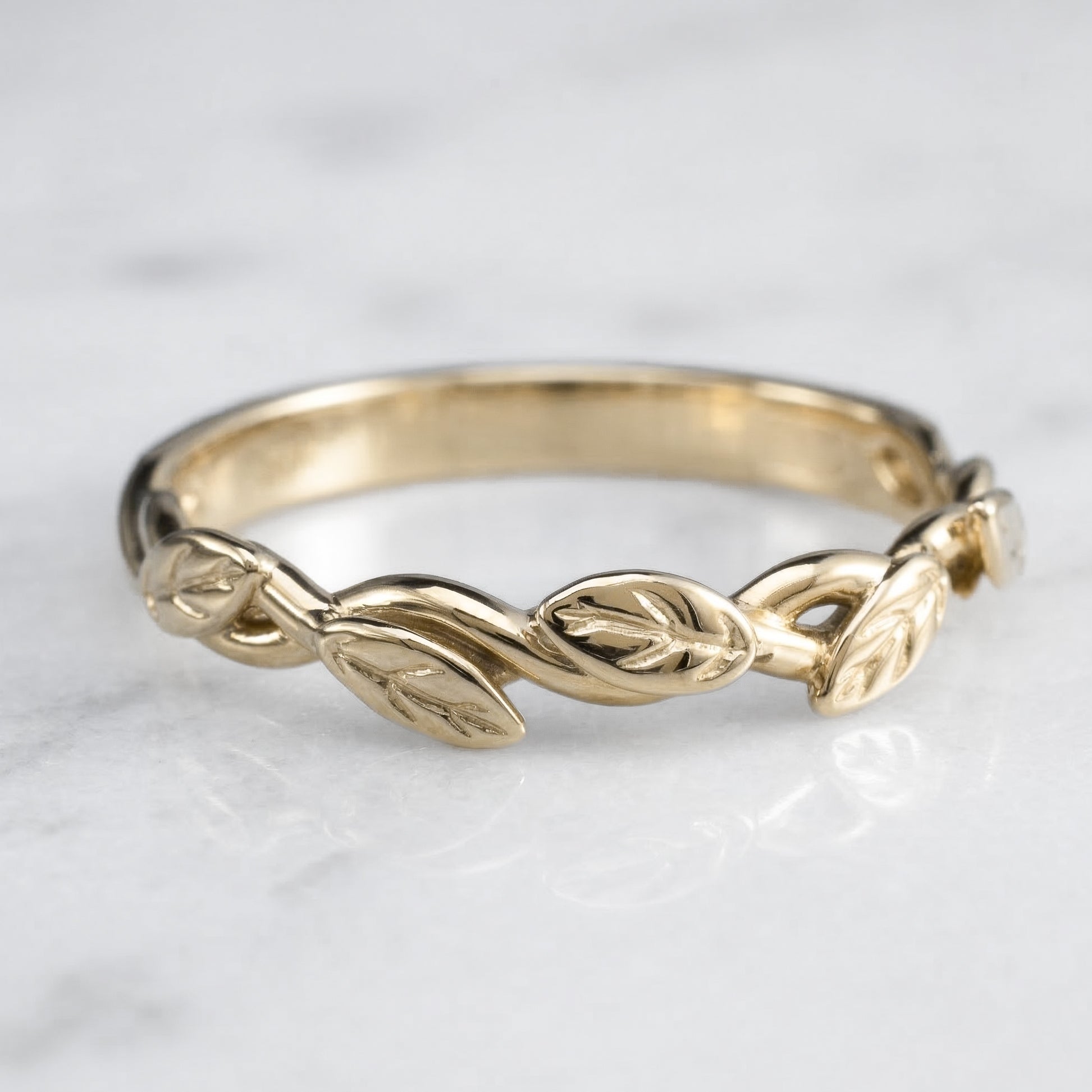 intertwined vine ring with leaves in solid yellow gold