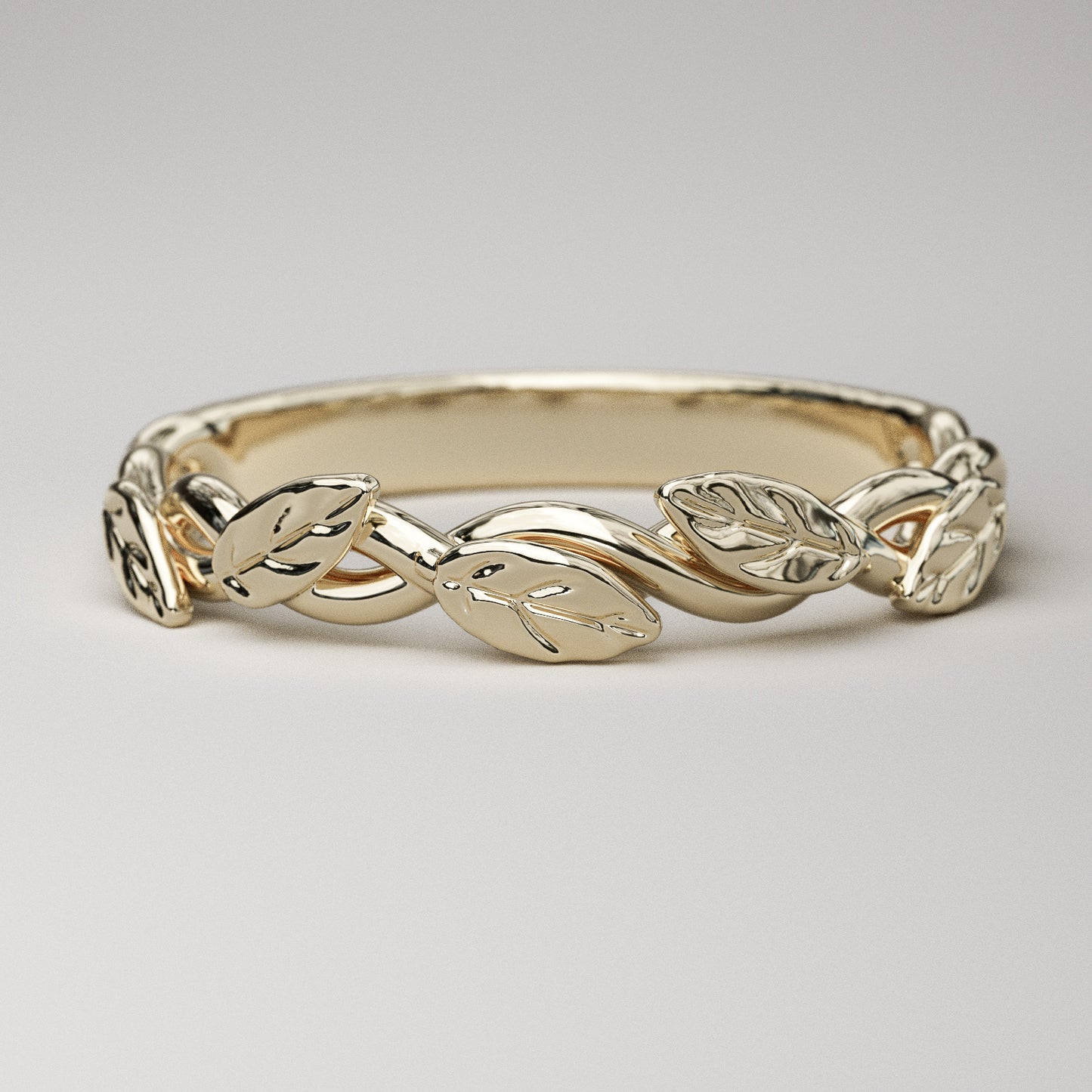 dainty leaf and vine wedding band in yellow gold