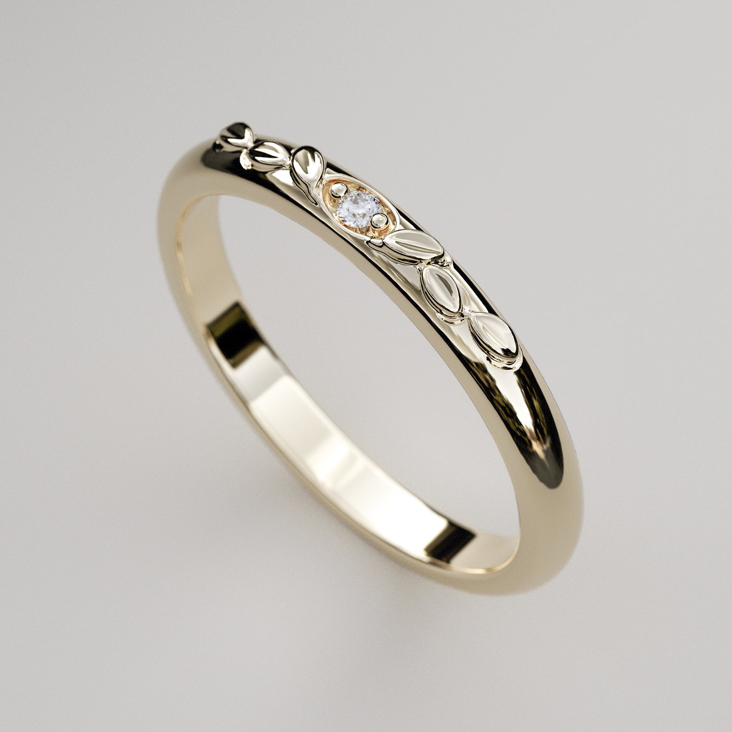 vintage inspired wedding band with leaves and small diamond in yellow gold