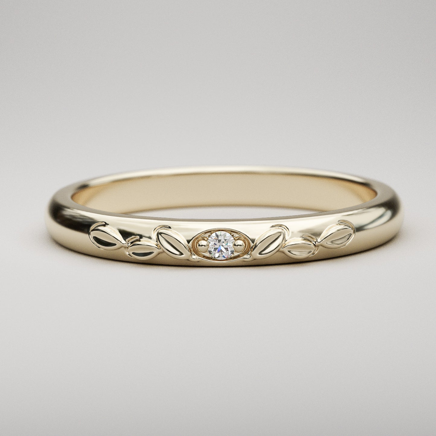 vintage inspired wedding band with leaves and small diamond in yellow gold