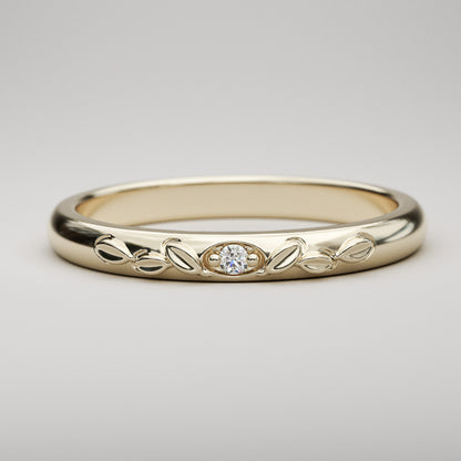 vintage inspired wedding band with leaves and small diamond in yellow gold