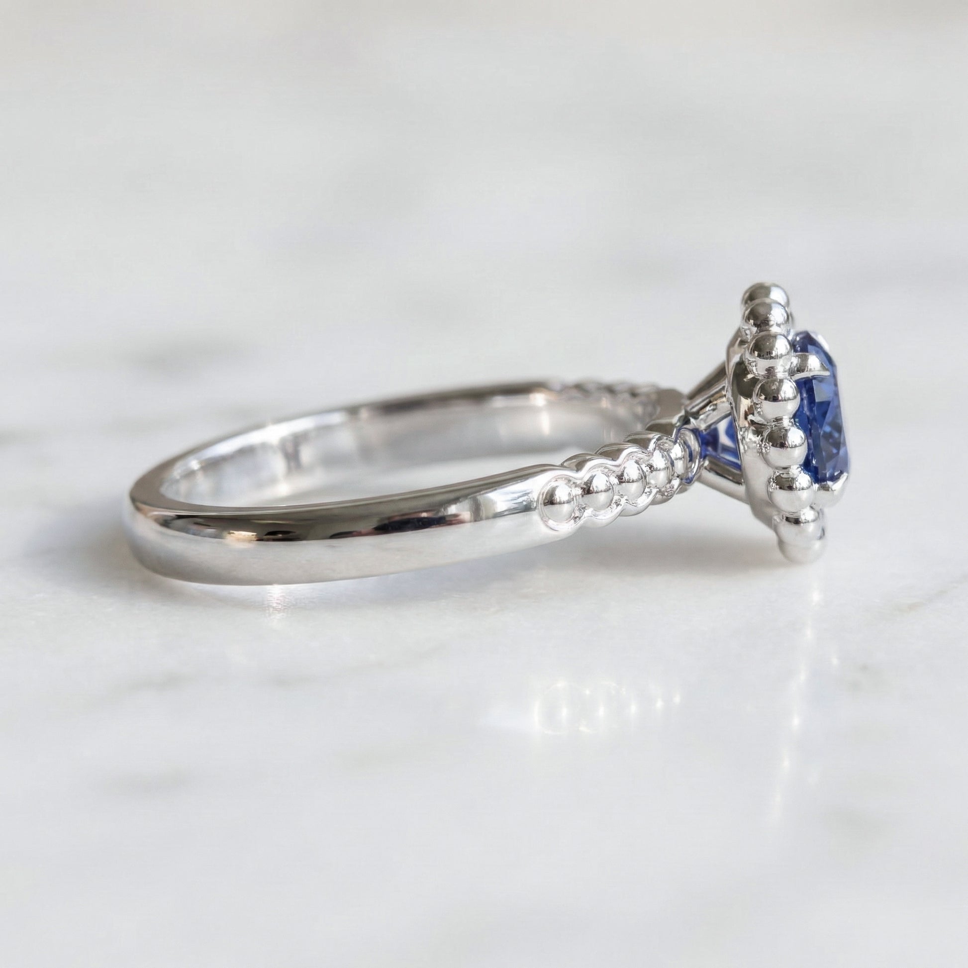 White gold ring with a blue gemstone