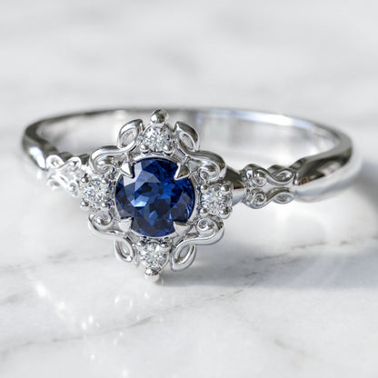 vintage style engagement ring with blue sapphire in white gold