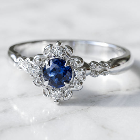 vintage style engagement ring with blue sapphire in white gold