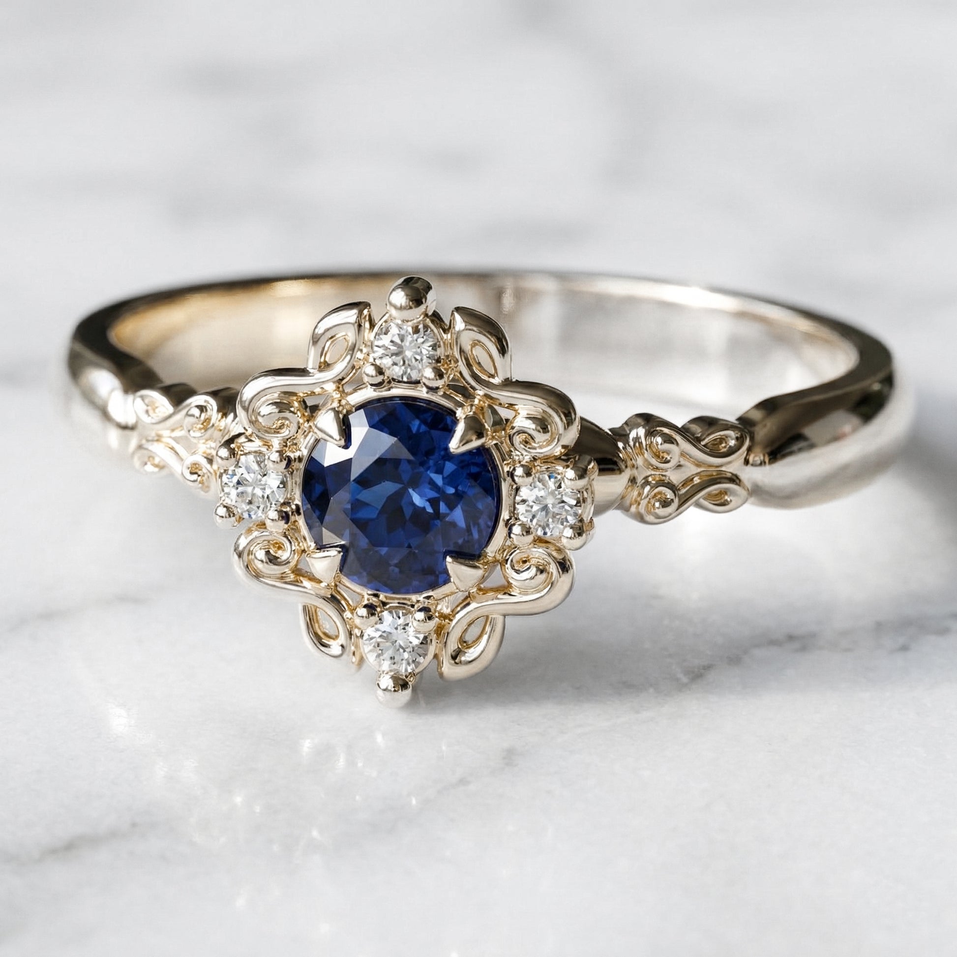 vintage style engagement ring with blue sapphire in yellow gold