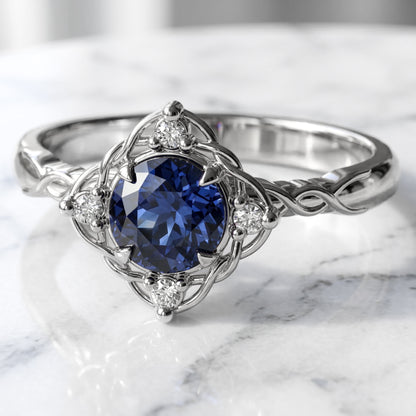 Filigree and diamond halo set medium blue sapphire in white gold settting