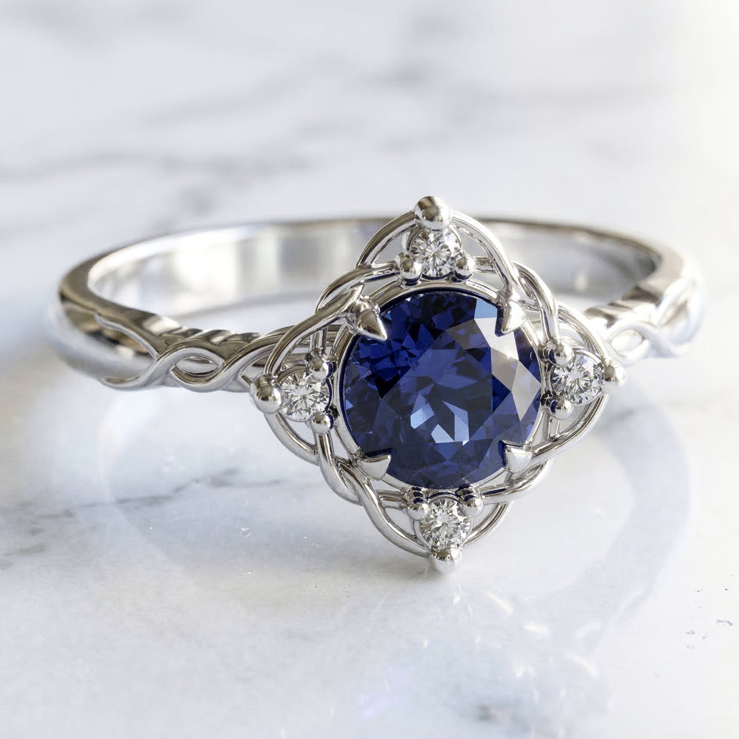 Filigree and diamond halo set medium blue sapphire in white gold settting